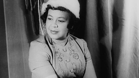 Image showing African-American composer Margaret Bonds, sitting in front of a curtain.