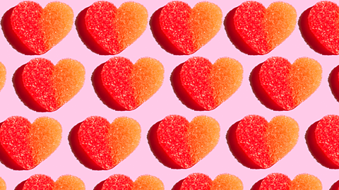 Red and orange love-heart shaped sweets.