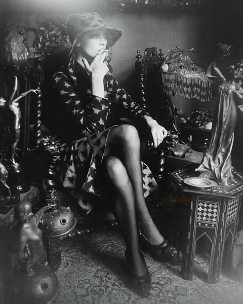 Barbara Hulanicki Archive A model surrounded by Art Nouveau and Art Deco objects in the home of Barbara and her husband Fitz's home (Credit: Barbara Hulanicki Archive)