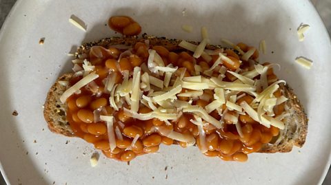 Beans on toast topped with grated cheese