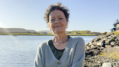 Composer Sally Beamish, standing next to the sea on Shetland