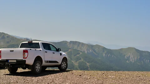 Getty Images A pickup truck parked in front of a mountain range (Credit: Getty Images)