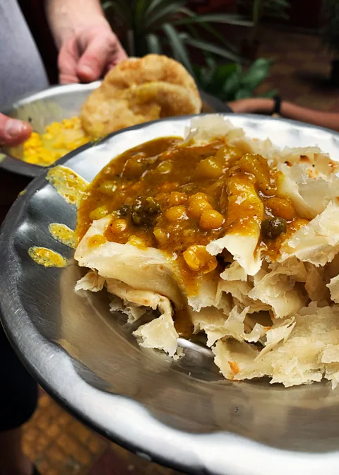 Auroni Mookerjee Gita mashi in the Gariahat fish market rolls out Mookerjee's favourite kochuri and petai porota – auntie style (Credit: Auroni Mookerjee)