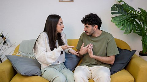 Young couple arguing on the sofa