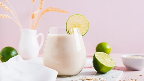 A glass of 'oatzempic' complete with lime and oats in the background