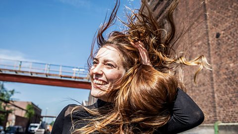 Woman with her long hair blowing in the wind