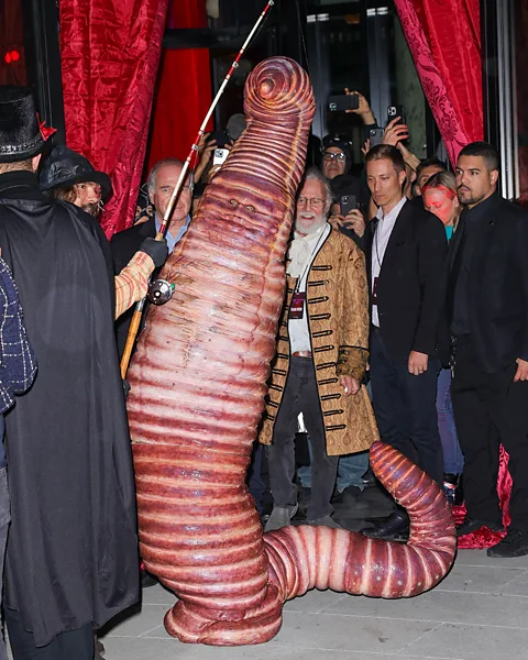 Getty Images Heidi Klum wore a worm costume for Halloween 2022 in NYC – scary disguises were originally intended to ward off evil spirits (Credit: Getty Images)