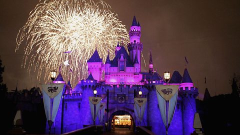 A Walt Disney fairy-tale castle with fireworks in the background.