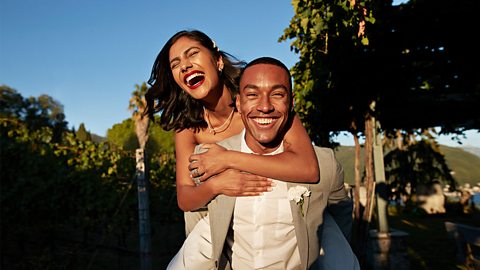 Bride having a piggy back from her new husband