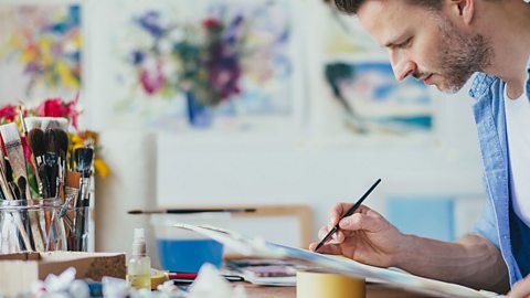 Male artist painting a watercolour