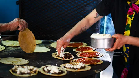 Alberto Lopez Memelas are Oaxacan grilled cornmeal cakes smothered with delicious toppings like cheese, salsa and vegetables. Try them at Memelas Doña Vale (Credit: Alberto Lopez)