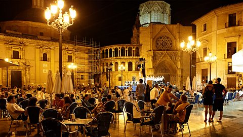 Crowded bar in a town square at night