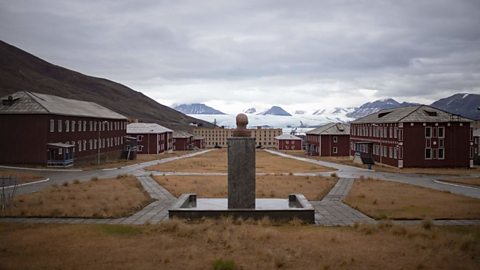 A statue of Lenin sits in the middle of the abandoned former Soviet miners village of Pyramiden