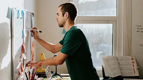 Getty Images Man writing on whiteboard (Credit: Getty Images)