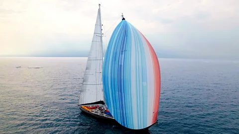 Northwest Passage Ocean Science Expedition/ Ramon Gonclaves The yacht Abel Tasman with its gennaker decorated with the climate stripes (Credit: Northwest Passage Ocean Science Expedition/Ramon Gonclaves)