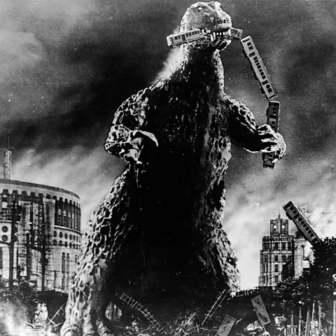 Getty Images A near-indestructible Leviathan with 'radioactive breath', Godzilla lays waste to Tokyo, knocking down buildings with his tail (Credit: Getty Images)