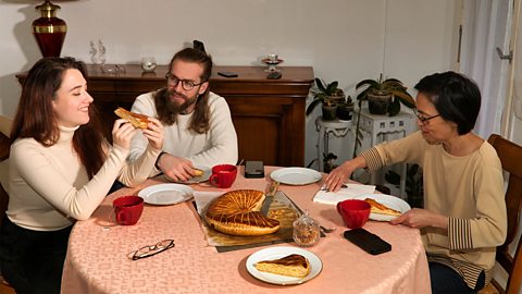A family eating a King's Cake together