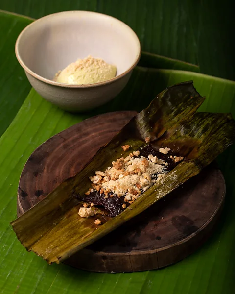 Geric Cruz Navarro makes a sticky purple rice cake topped with candied cashew, candied pinipig and polvoron (Credit: Geric Cruz)