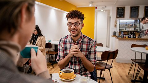 Two friends drinking coffee in a café