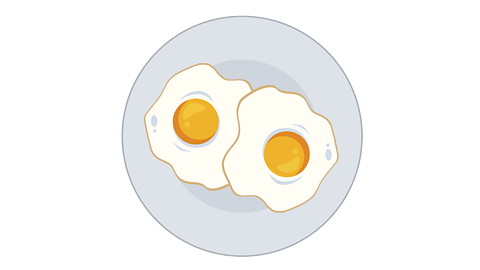 Two cooked eggs on a plate