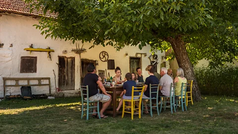 Getty Images Eating meals together has been linked to higher levels of wellbeing, studies say (Credit: Getty Images)