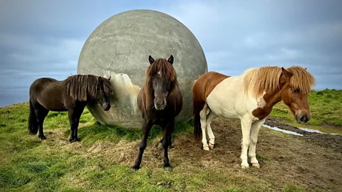 Michelle Gross Tourists – and Icelandic horses – seek out the island's Orbis et Globus concrete ball (Credit: Michelle Gross)