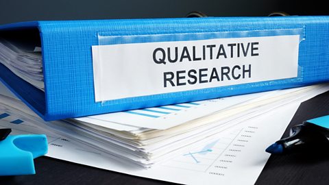 A blue leaver arch file with Qualitative research written on its spine