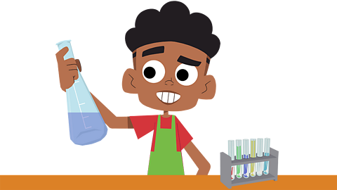 A young child in an apron holding a flask of liquid
