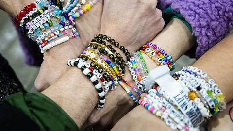 Getty Images In every stadium thousands of forearms were weighed down by stacks of hand-crafted bracelets traded with strangers (Credit: Getty Images)