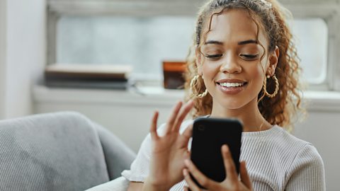 A young woman looking a promotional content on her mobile phone