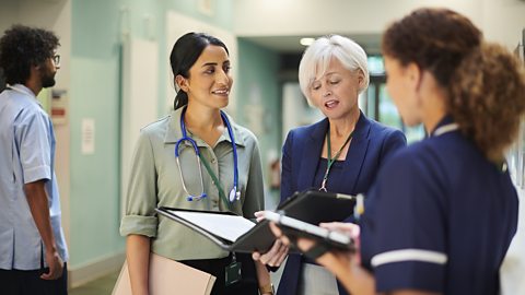 Healthcare administrator speaking with the healthcare team.