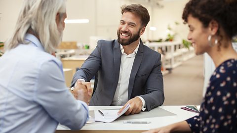 Man being recruited at a job interview. A contract of employment is on the table.