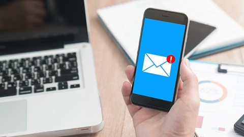Person looking at a mobile phone that has got an internal recruitment email.