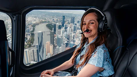 Nic Morely Melanie Zanetti in a helicopter overlooking the city of Brisbane, Australia (Credit: Nic Morely)