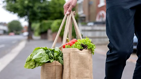 Getty Images A person carries a shopping bag full of vegetables (Credit: Getty Images)