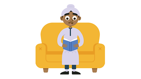 Child Rohan sitting on a sofa reading a book.