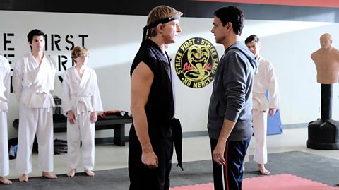 A scene from Cobra Kai featuring William Zabka and Ralph Macchio