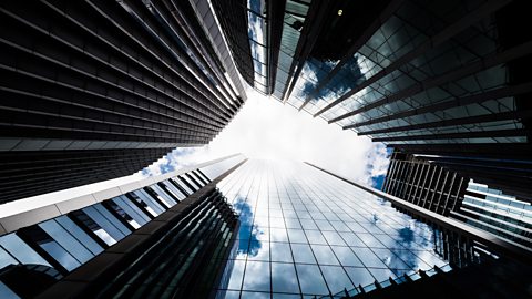 A circle of high rise offices photographed from the ground