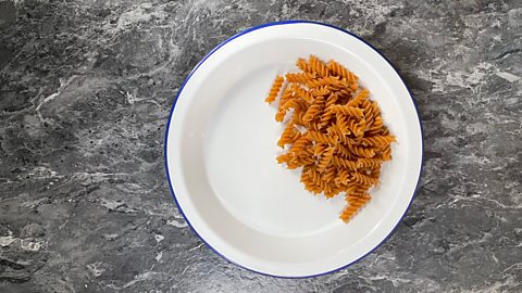 75g of dried pasta on a plate