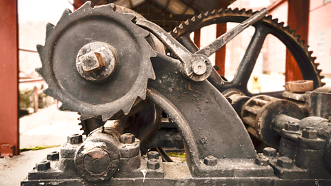 A heavy iron ratchet and pawl mechanism with a lever acting as a pawl