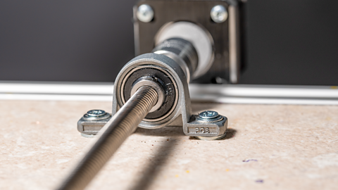 Stepper motor with endless screw shaft and bearing