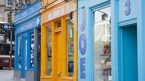 Colourful shop fronts on a street in Scotland.