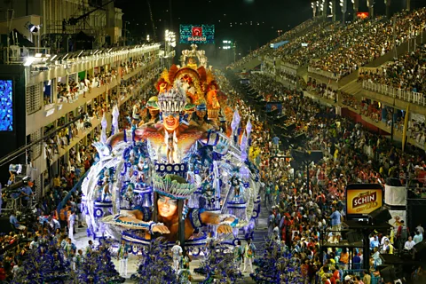 Alamy A Carnival parade surrounded by crowds on a street in Rio de Janeiro (Credit: Alamy)