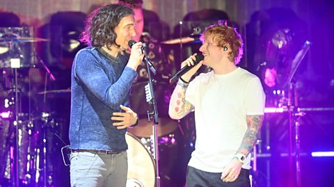 Gary Lightbody of Snow Patrol and Ed Sheeran performing on stage