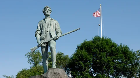 Alamy The Minuteman statue in Lexington, Massachusetts, with an American flag flying in the background (Credit: Alamy)