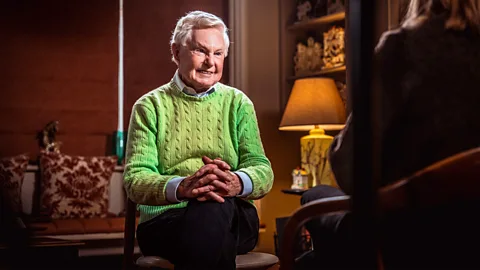 Jack Flynn Sir Derek Jacobi sat on a chair with his hands interlinked, facing forwards (Credit: Jack Flynn)