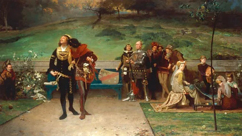 Alamy A 19th-Century painting by Marcus Stone of Edward II and Gaveston, showing them getting closer while courtiers look on (Credit: Alamy)