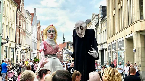 Carola Ferch A tour lets visitors follow towering Nosferatu-inspired papier-mache puppets through Wismar's medieval streets (Credit: Carola Ferch)