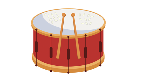 An illustration of a drum with rice on the skin.