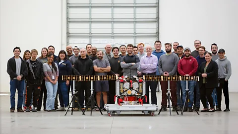 AstroForge AstroForge teammates assemble behind the Odin spacecraft, with its solar array panels open, in January 2025 ahead of its February launch (Credit: AstroForge)